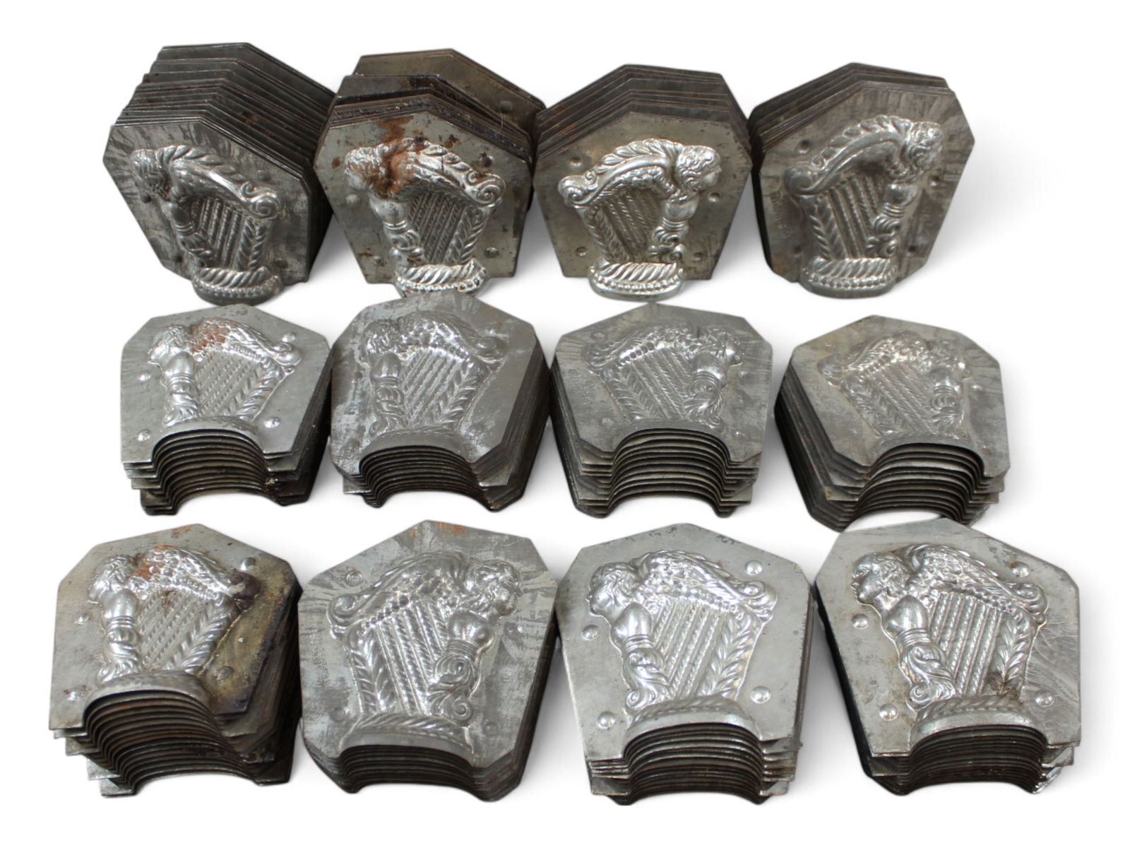 50+ Chocolate Molds of Angel with Harp: Over 50 pieces of Chocolate molds depicting an Angel with Harp. Some are marked JaBurg Brothers. Each approx. 5" x 4-1/4". Most show wear with surface rust.