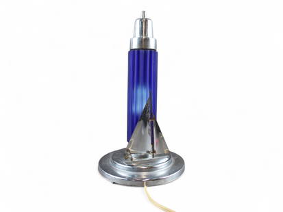 Sarsaparilla Art Deco Sailboat Table Lamp: Art Deco Sailboat Table Lamp, by Sarsaparilla. Overall approx. 12" high x 6" wide. Chrome plated with cobalt like blue shade which features a ribbed body. Tested and in working condition. The small sa