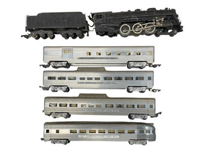 5pc American Flyer 320 Pass Set: S Gauge. Includes a 320 NYC Hudson steam loco, showing heavy play wear; 660 Baggage; 2-662 Vista-domes; 663 Observation. Aluminum cars show moderate play wear. From The Estate Collection of Joel Cane.