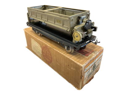 Super Boxed Lionel 218 Side Dump Car: Standard Gauge. 3rd version with painted ends, tipple gear original, light signs of fatigue. It is very clean and shiny, showing light handling with label-end box. Great Example!