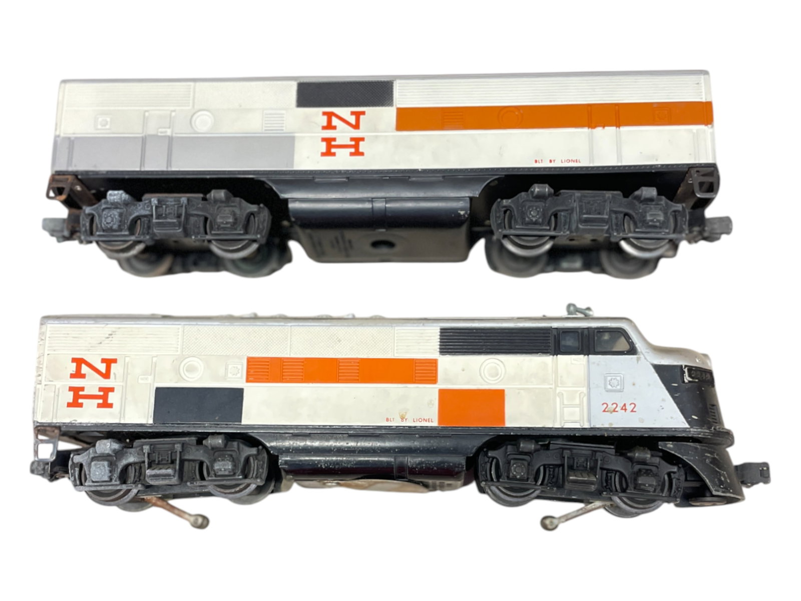 Lionel 2242 NH F3 AB Diesels: 1958. Matched shells, but need a cleaning. Chassis OK, clean battery box, a few moisture spots on trucks. They show light to moderate play wear.
