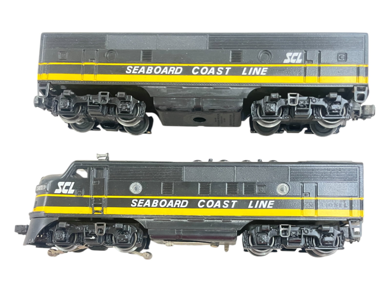 Custom Painted Lionel Dual Motor F3 AB Diesels: Done in Seaboard Coast Line. Nice job with good details. Dual Motor chassis shows moderate run time with clean battery box.
