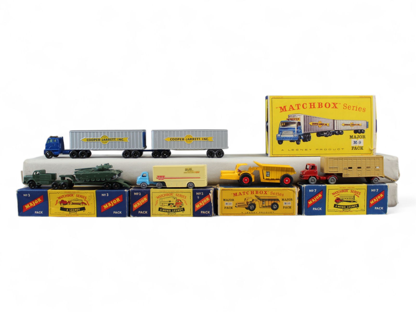 (5) Vintage Matchbox Major Pack Vehicles: Includes M-7 Cattle Truck, M-2 Bedford Articulated, M-3 Tank Transporter and Centurion Mark III Tank, M-10 Whitlock Dinkum Dumper, and M-9 Inter-State Double Freighter. Most show playwear with scuffs