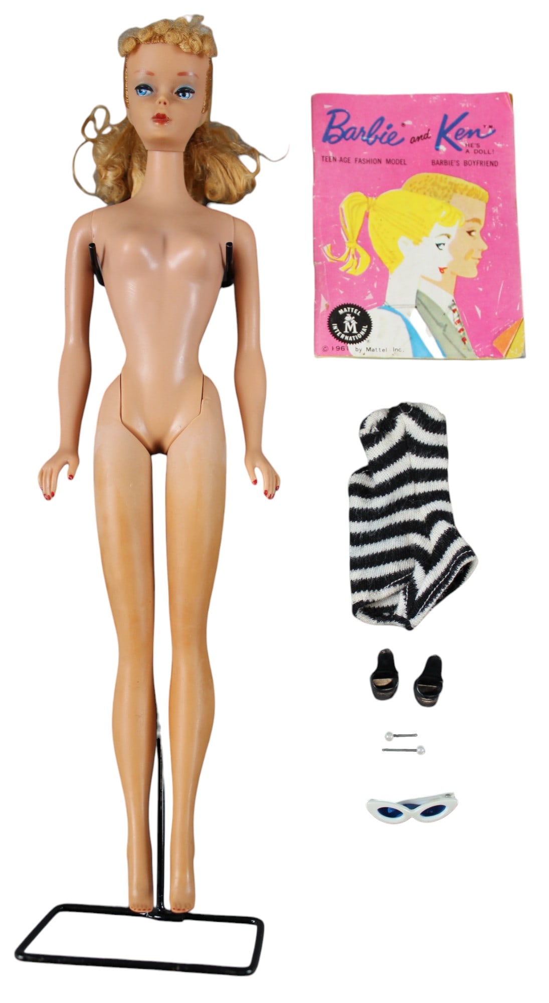 Barbie #4 Blonde: Includes black and white zebra swimsuit, black open toe heels, pearl earrings, white sunglasses (missing a temple), black stand, and booklet.