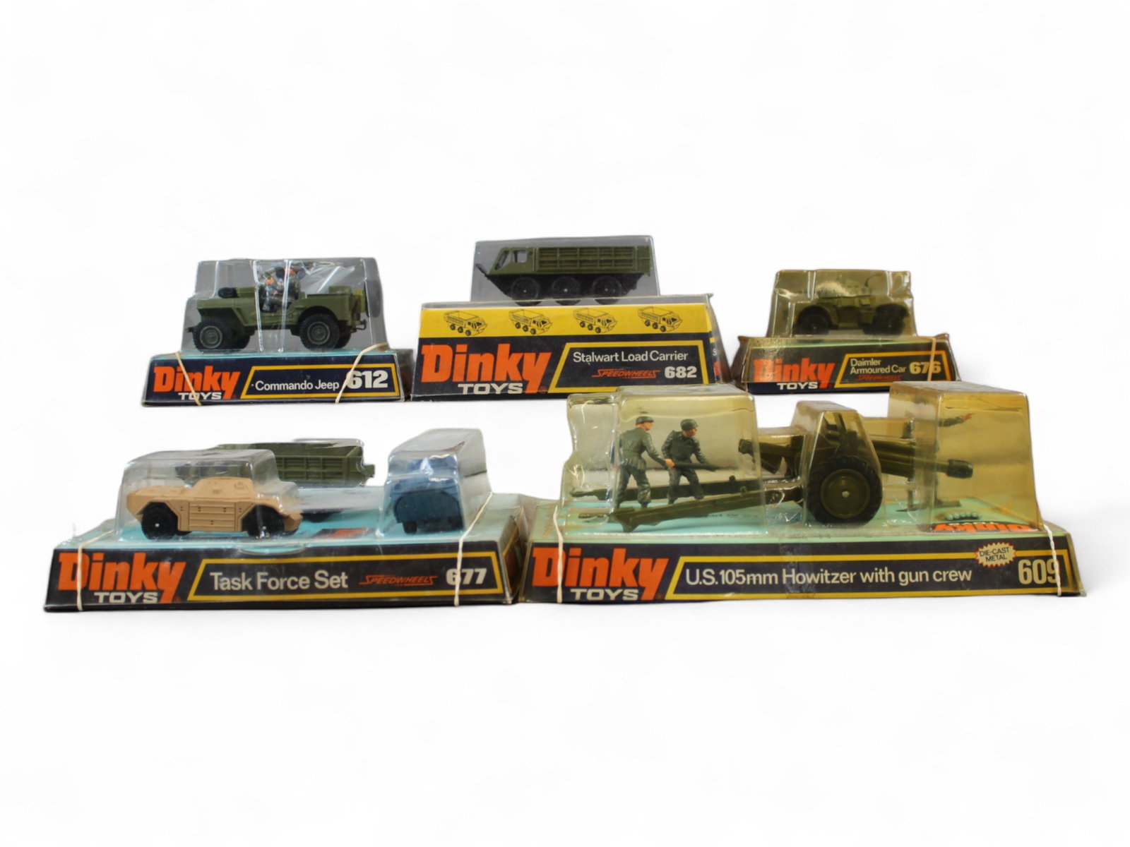 5pc Boxed Dinky Military Pieces: Includes 609 US 105 MM Howitzer with gun Crew; 677 3pc Tack Force set; 612 Commando Jeep with accessories; 682 Stalwart Load Carrier; 676 Damlier Armored car. All appear like new with shop worn boxes.