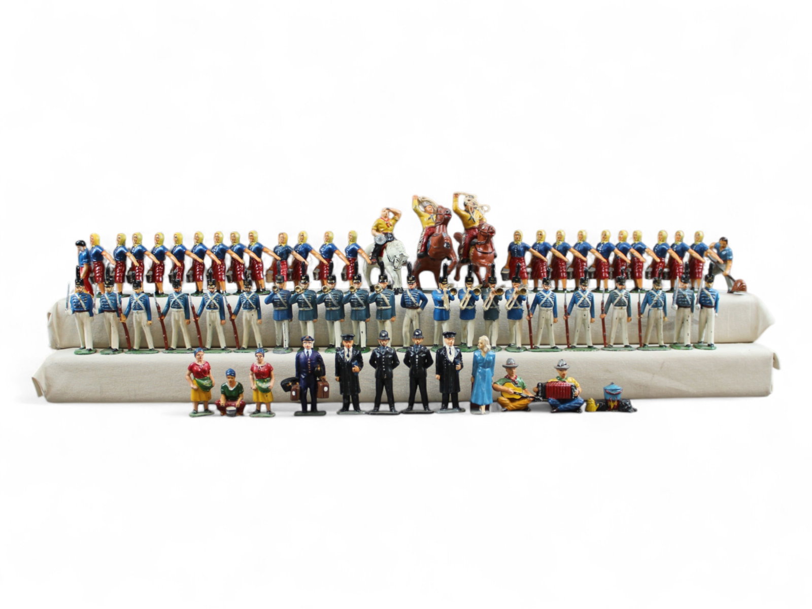 Military and Civilian Toy Figures: 60+ civilian and cadet Timpo and similar toy soldiers. Mixed conditions.