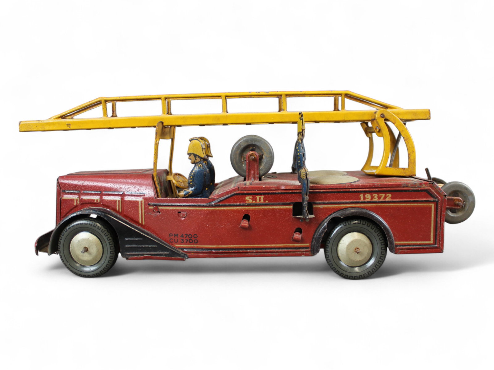 Joustra Fire Escape: France. Circa 1935. Litho tin with metal wheels, 13? long. has 4 attached fireman, spring loaded ladder, missing 1 axe on side. It has partial original hose and hook line on spools, mechanism is untes