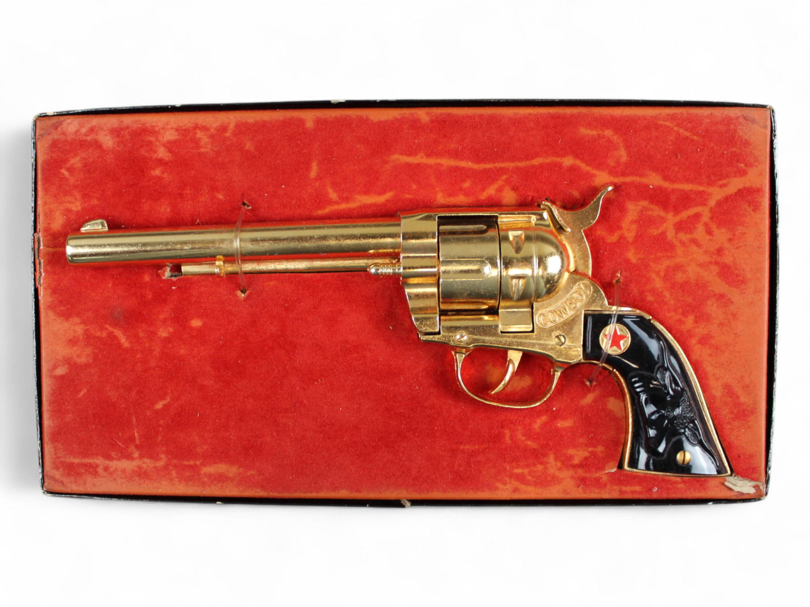 Boxed Hubley Cowboy Classic Gold Plated Cap Gun: Hubley No.276 Cowboy Classic repeater cap gun with gold-plated finish and black grips featuring a raised black bull and red star motif. Approx. 11-3/4" long. Appears to have never been removed from it