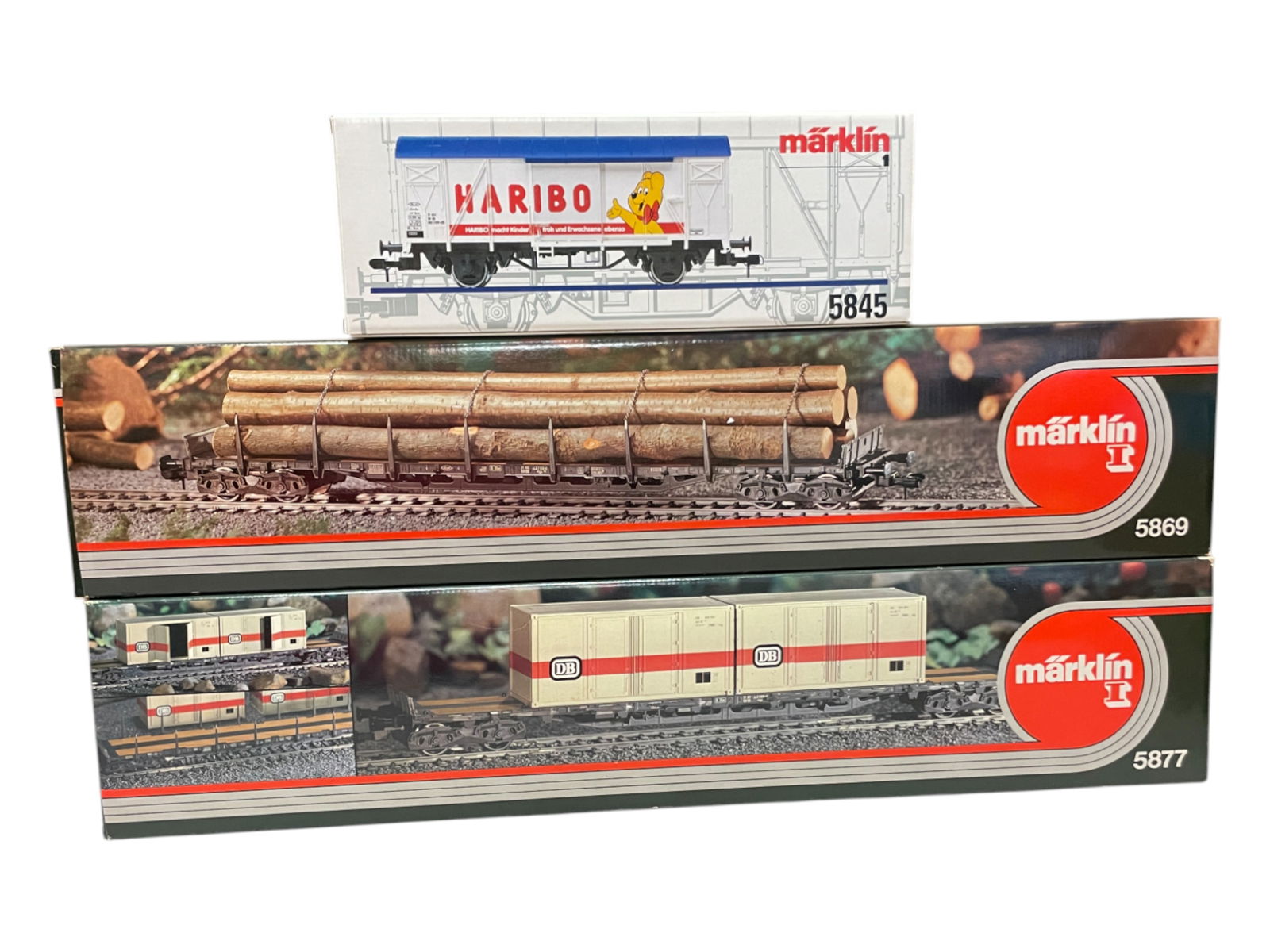 3 Marklin 1/G Gauge Freights: 1/G Gauge. Includes 5877 Long Container Car; 5869 Long Log Hauler; 5845 Haribo Goods wagon. All appear new in boxes.