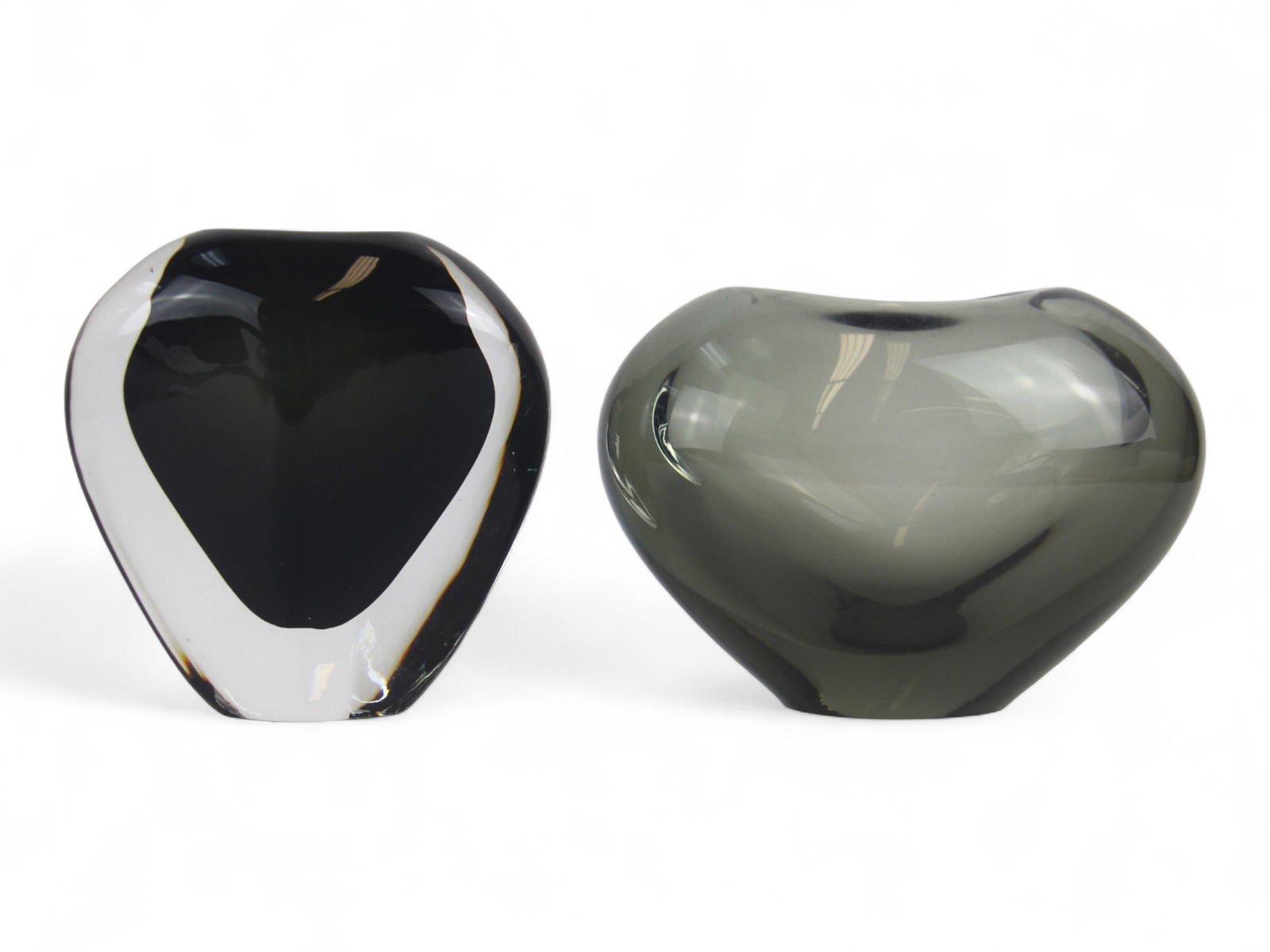 Holmegaard & Orrefors Art Glass Vases: Group of (2) Scandinavian art glass vases. The first, a Holmegaard clear and smoky gray heart form vase, signed and dated 1962 on base, approx. 4" high. The second, an Orrefors faceted vase with thick