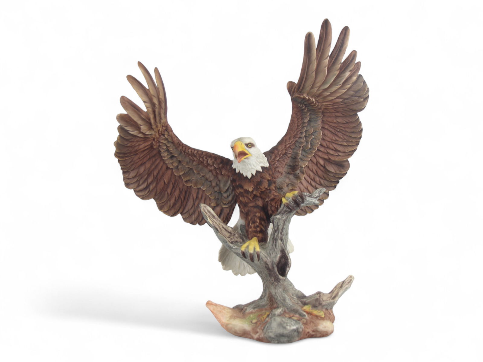 Boehm American Bald Eagle Porcelain Sculpture: Edward Marshall Boehm Studio porcelain sculpture of the American Bald Eagle, wings spread, perched on a naturalistic tree base. Marked on underside Edward Marshall Boehm Studio - American Bald Eagle -