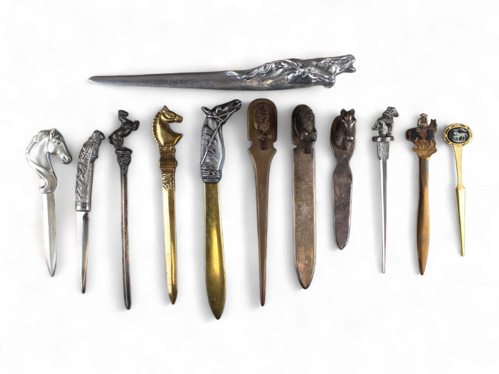 Equestrian & Racing Letter Openers: Group of twelve equestrian and racing themed letter openers in various materials and by various makers. Includes Reed & Barton. Shipping: Weiss Auctions offers full-service, in-house shipping for near