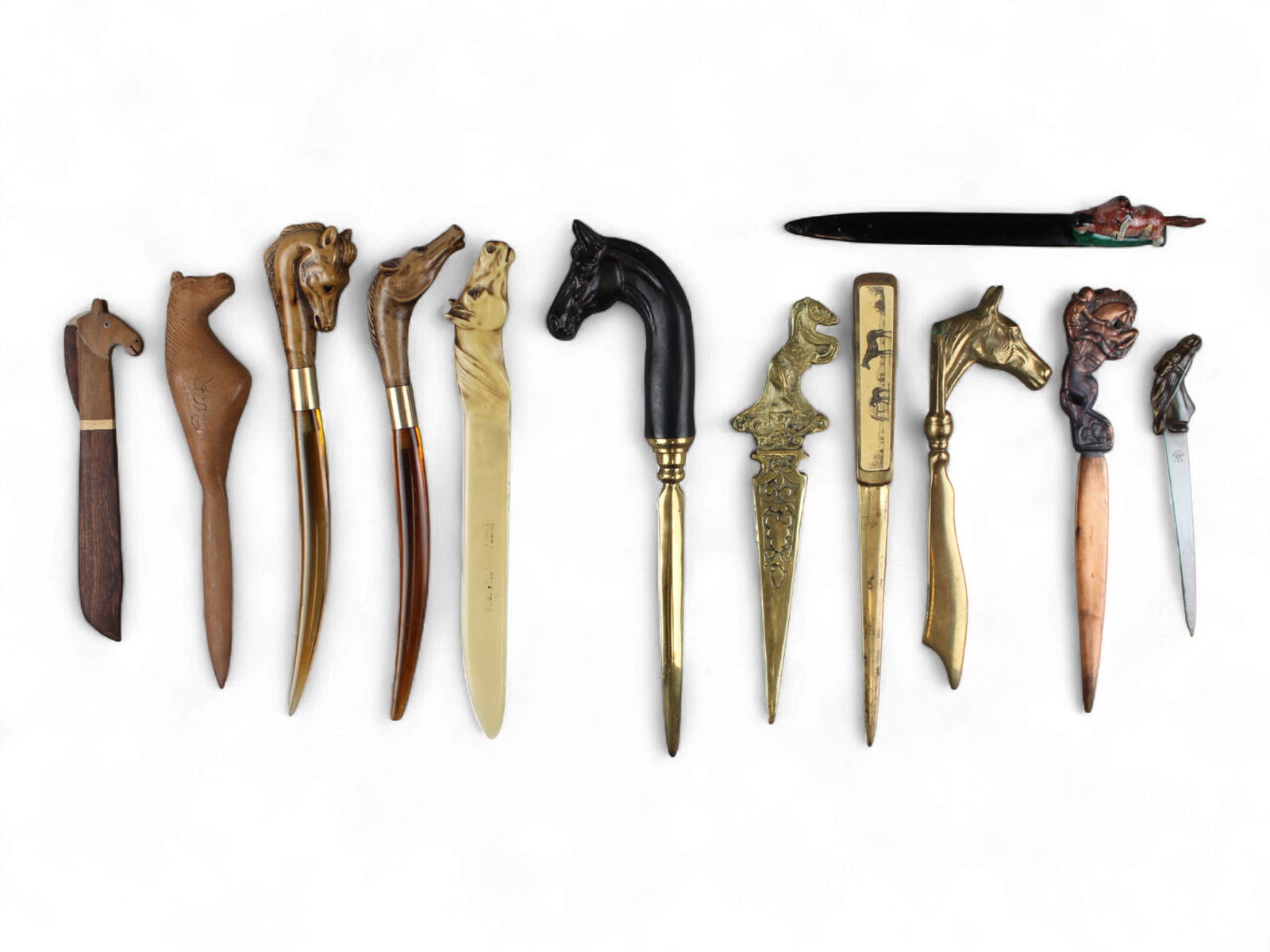 Equestrian & Racing Letter Openers: Group of twelve equestrian and racing themed letter openers in various materials and by various makers. Shipping: Weiss Auctions offers full-service, in-house shipping for nearly all items in this auc
