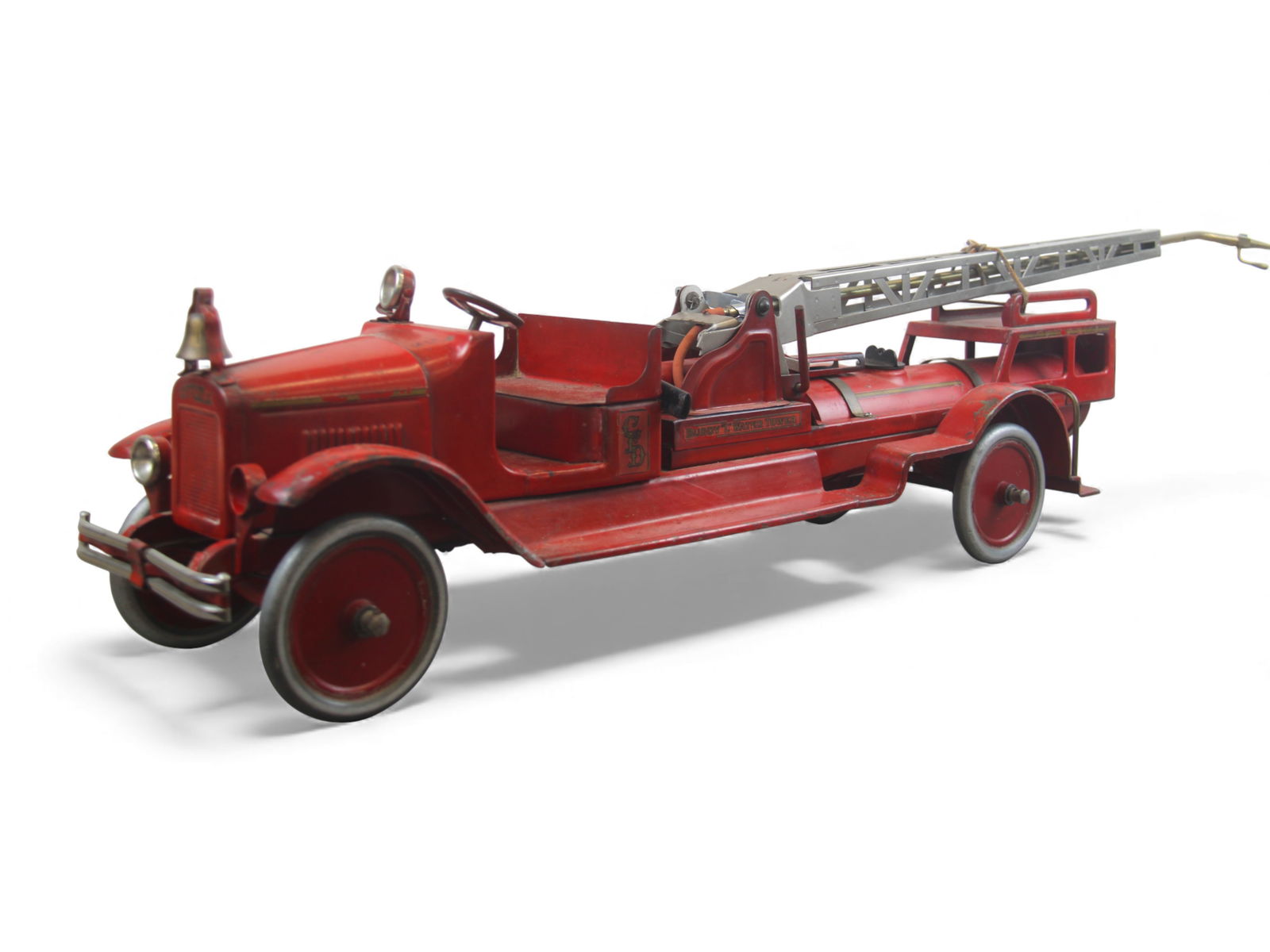 Buddy L Water Tower Fire Truck: Early pressed steel Buddy L "Water Tower" fire truck in red with original decals, red disc metal wheels, and nickel tower structure. Features water tank, pump mechanism (not working), bell, and worn o