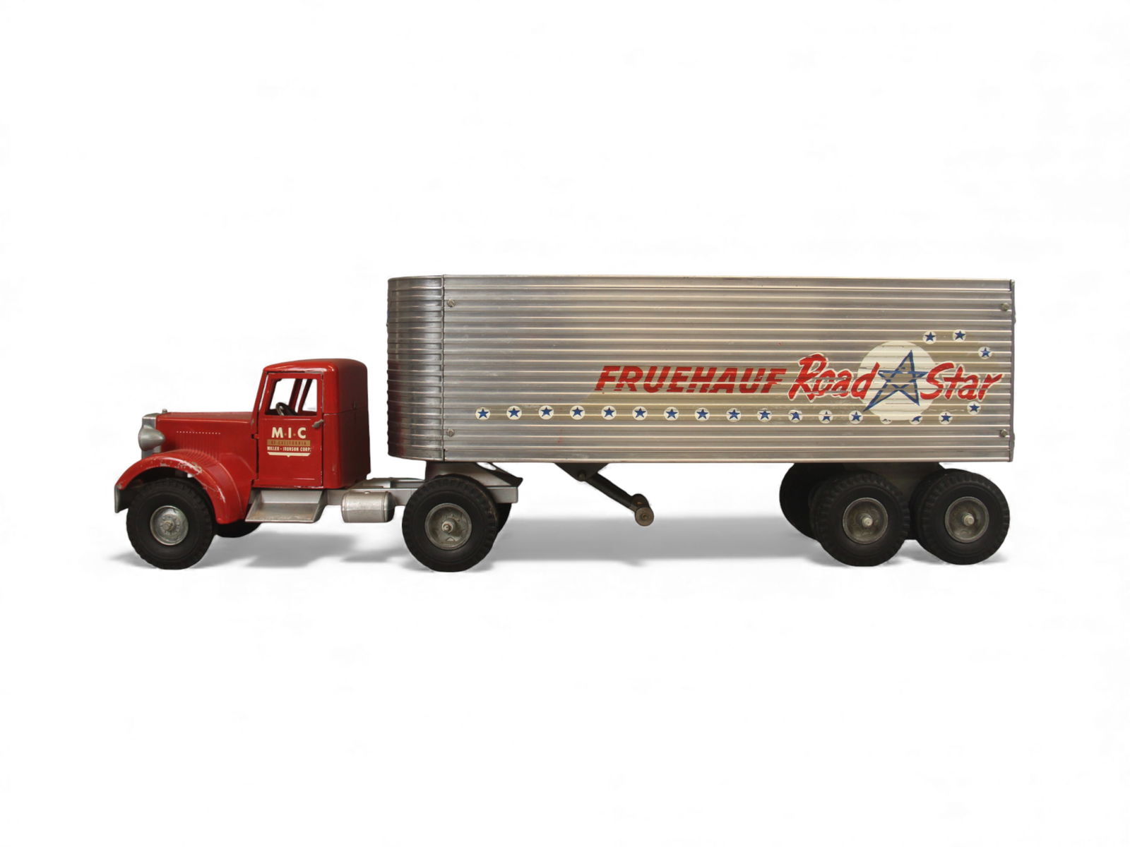 Smith Miller MIC Fruehauf Road Star Truck: Vintage Smith Miller MIC Fruehauf Road Star tractor trailer with red pressed steel cab and aluminum ribbed side van trailer. Original decals are present, some show wear. Driver and passenger doors