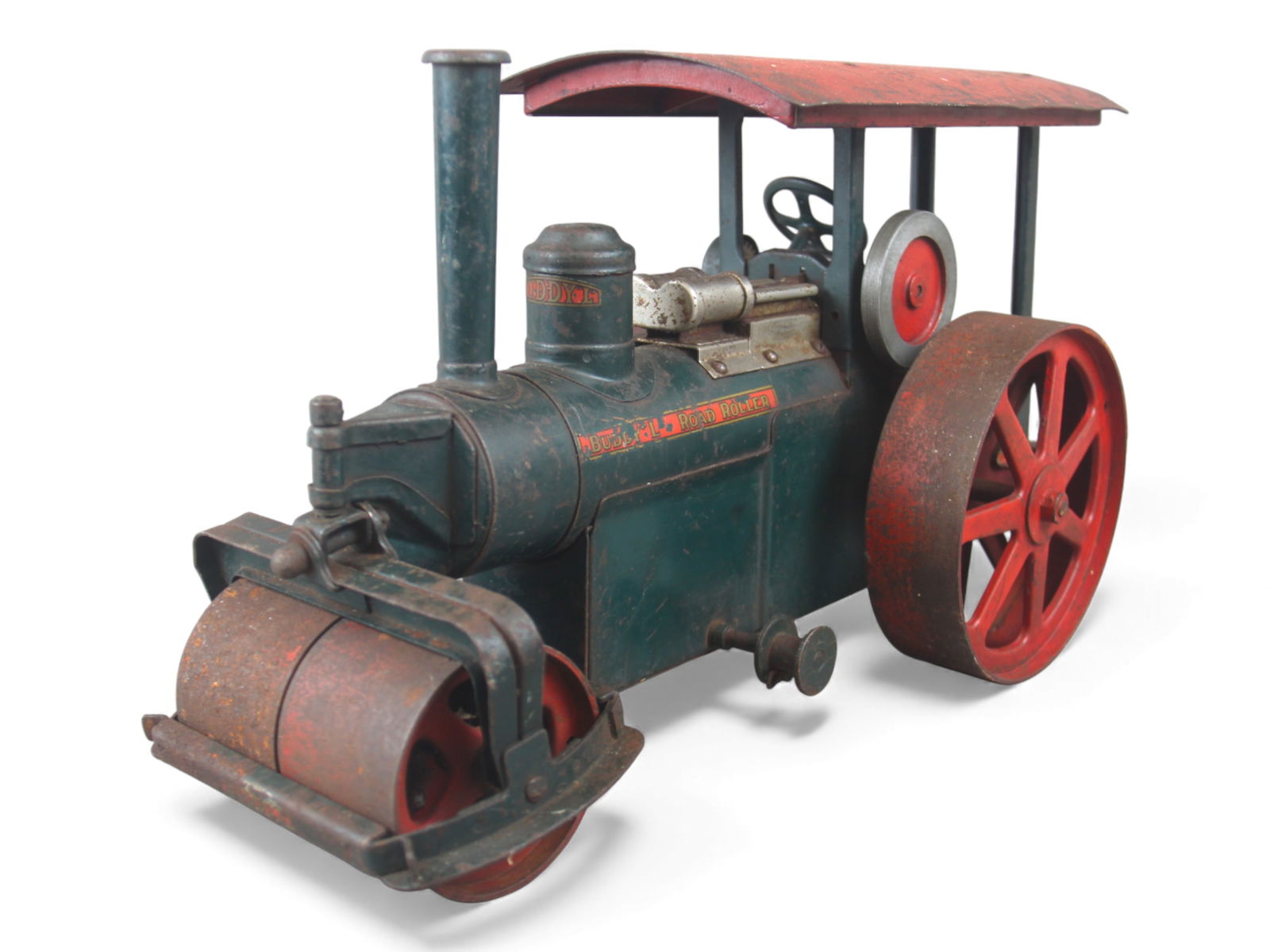 Early Buddy L 290 Road Roller: Desirable model, painted pressed steel, 19" long. Wheel steers front roller, roller pinion screw is broken, missing chains. Decals are 50%. It would benefit from a clean and polish. Worth the TLC need