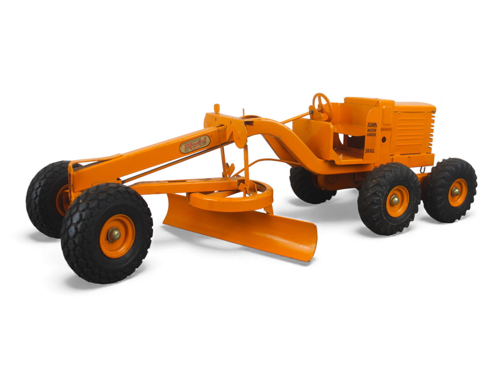 Nice 1949 Doepke Adams Grader: Model Toys 26" scale grader made of pressed steel with rubber tires. It has flexible suspension and blade position; steering wheel functions. It is clean and shiny, showing light play wear. Better