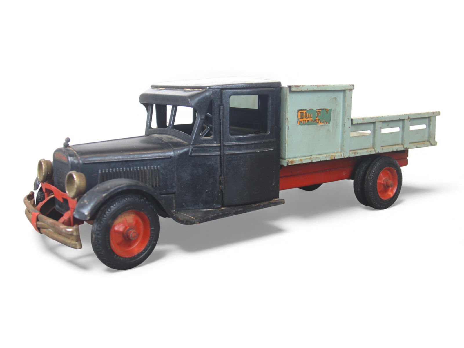 Scarce Buddy L Jr Milk Delivery Truck: Painted pressed steel, 24" long. It is over-painted, rear done around decals. It has opening cab doors, functional steering wheels and nice headlights. Great restoration candidate. Shipping: Weiss