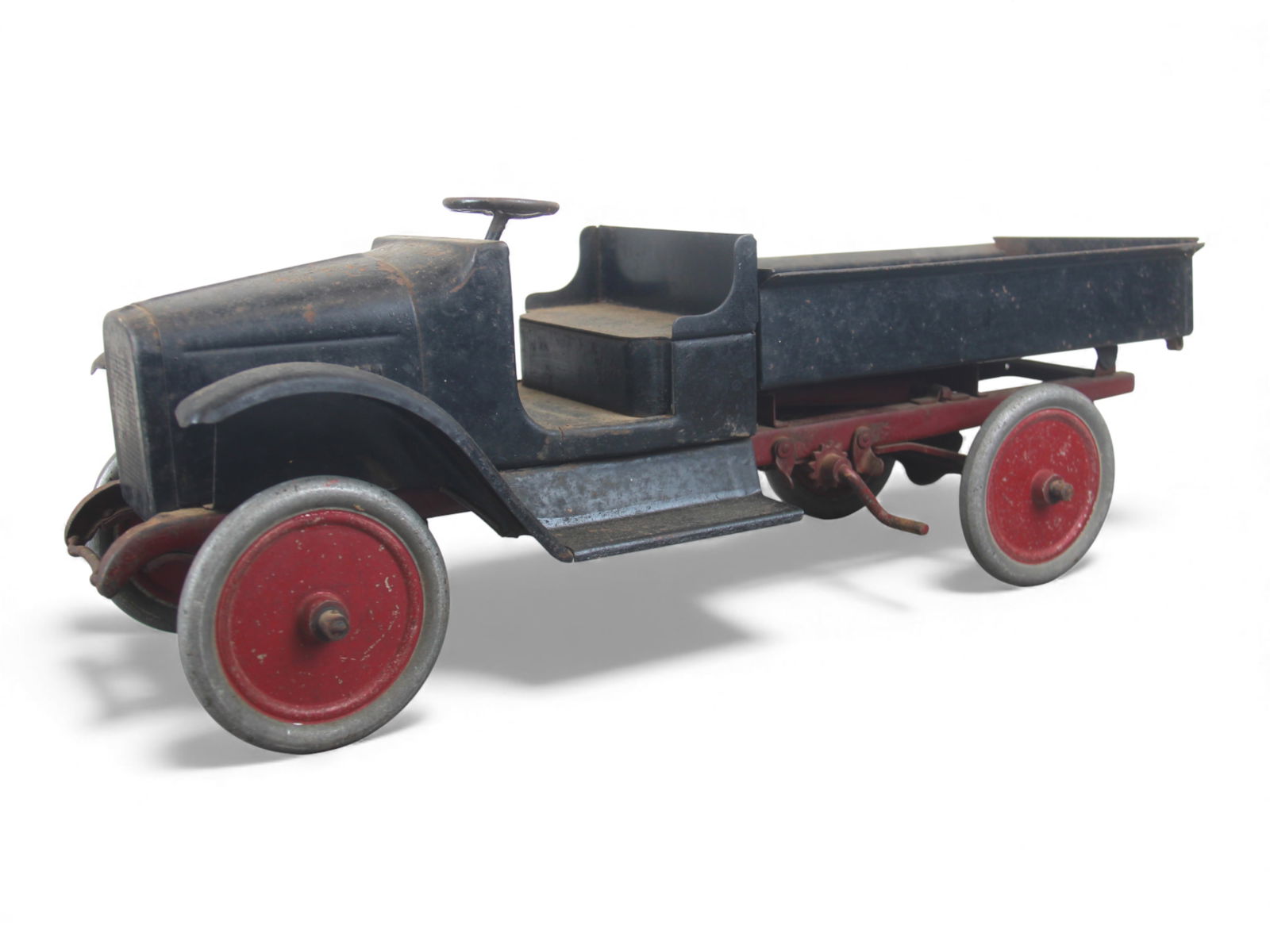 1927 Buddy L Mechanical Dump Truck: Painted Pressed steel, 23 1/2" long. Chain pull dump functions, steering works, some over-paint. Would benefit from a good cleaning. Shipping: Weiss Auctions offers full-service, in-house shipping