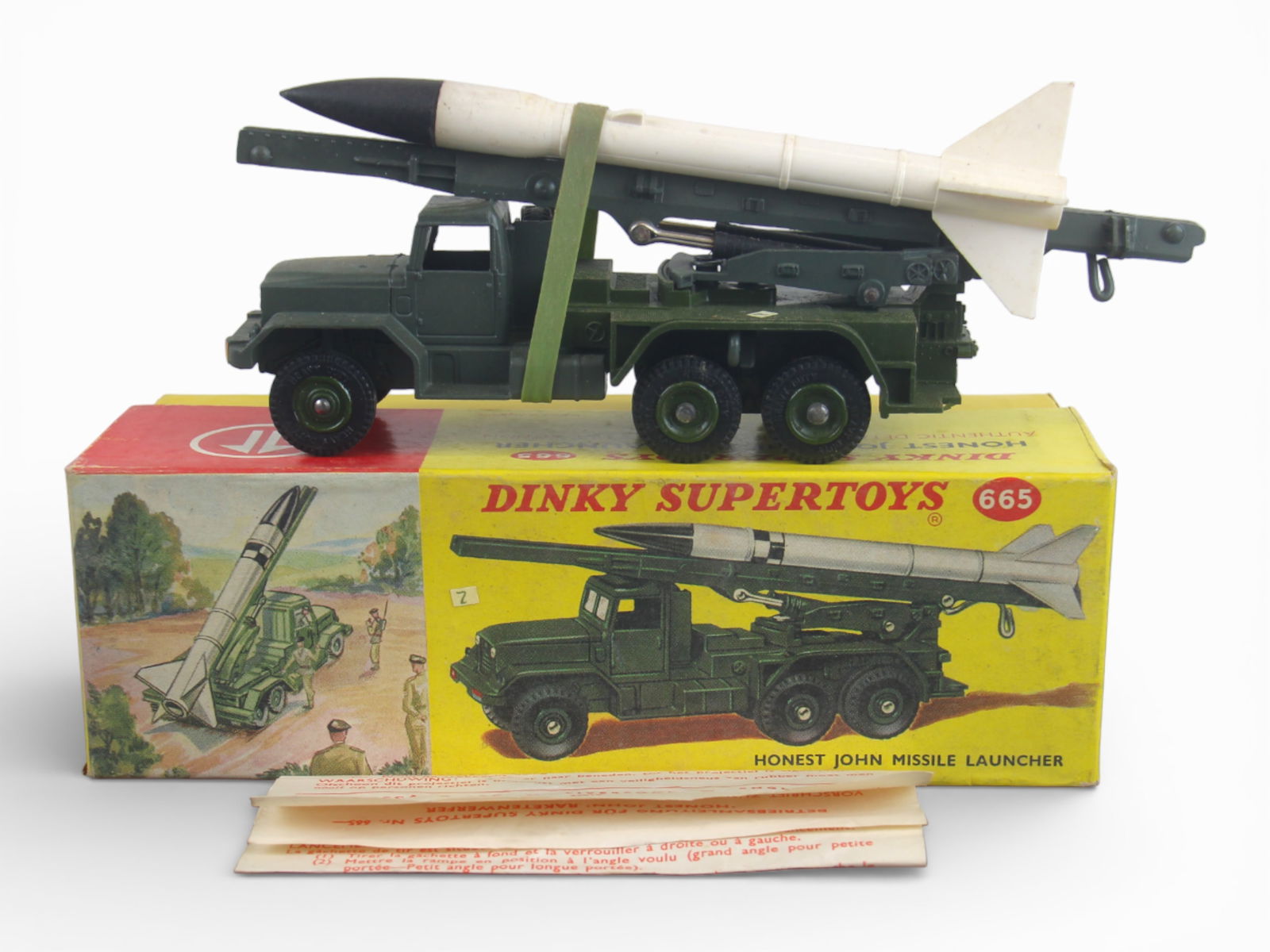 Nice Boxed Dinky 665 Honest John Missile: Clean olive drab painted die cast, about 1:43 scale. includes a mobile launcher with functional mechanism. Has original intact rocket with nice rubber top. It has its instructions, shows light use