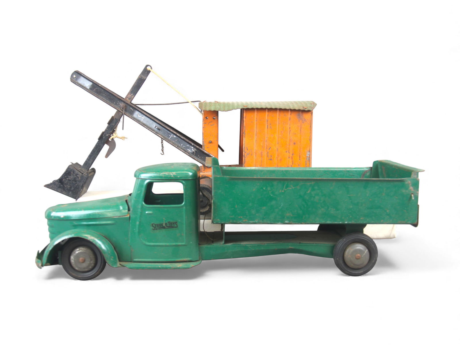(2) 1940s Structo Trucks: Includes a painted pressed steel Dump Truck, with rubber tires, 21" long, dump functions with moving tail gate, decals are nice and has an opening hood. It is missing one headlight and would benefit f