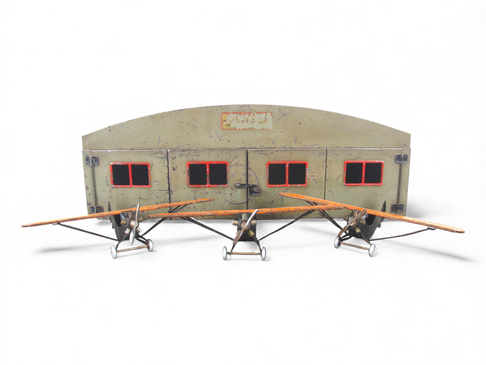 4pc Buddy L Airways Corporation: 1930. Includes a 20" wide pressed steel hangar with full gate opening doors, missing windsock. Decal 25%; includes 3 pressed steel Mono planes, each with 10" WS, with nice motor details. All show