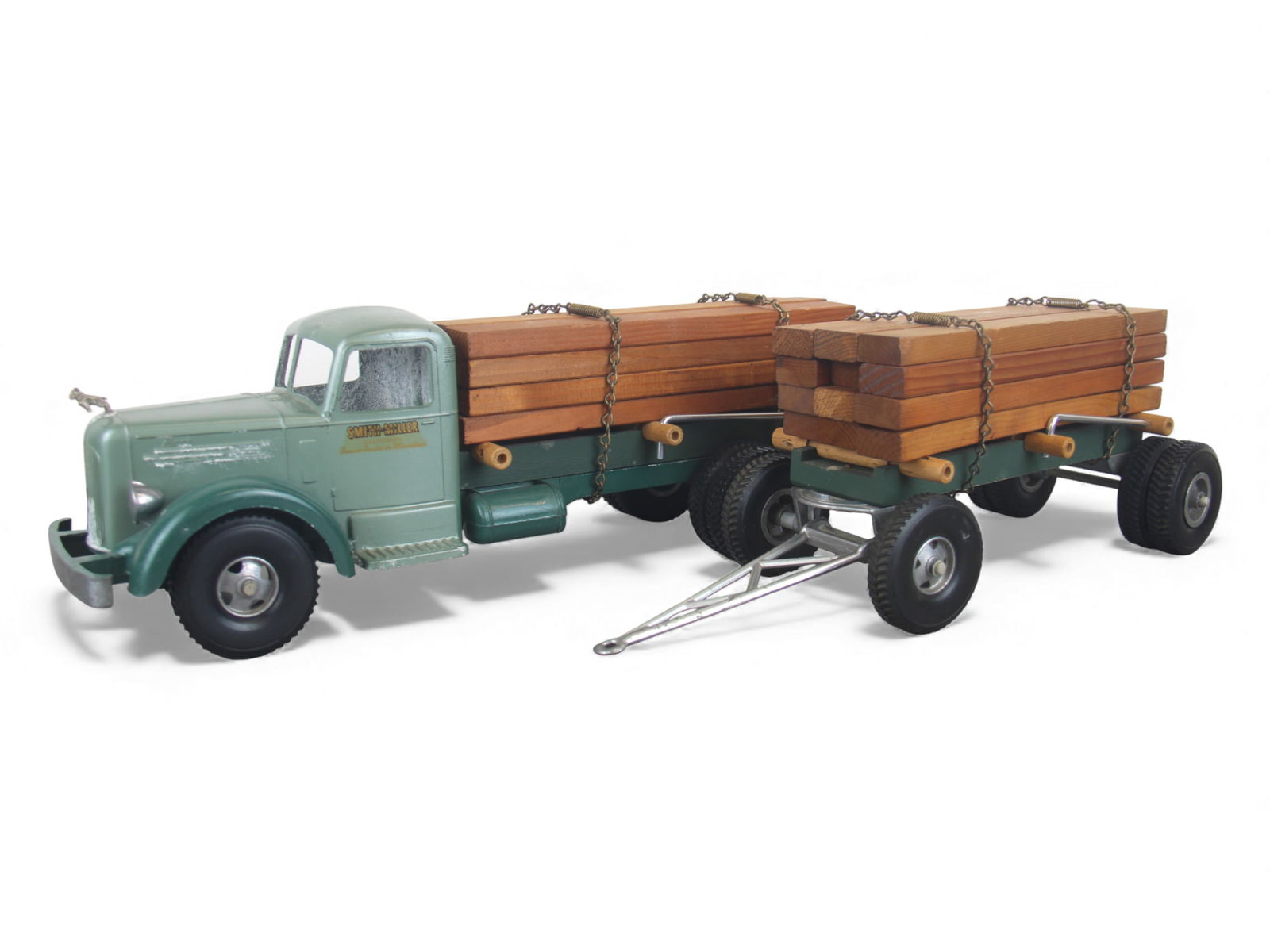 Vintage Smith-Miller Mack Lumber Truck & Pup: Painted die cast with rubber tires, over-all length 28". It is in nice shape, but stored around moisture, so inside and a bit on grill has mildew/corrosion. Some may clean off. The wood and chains are