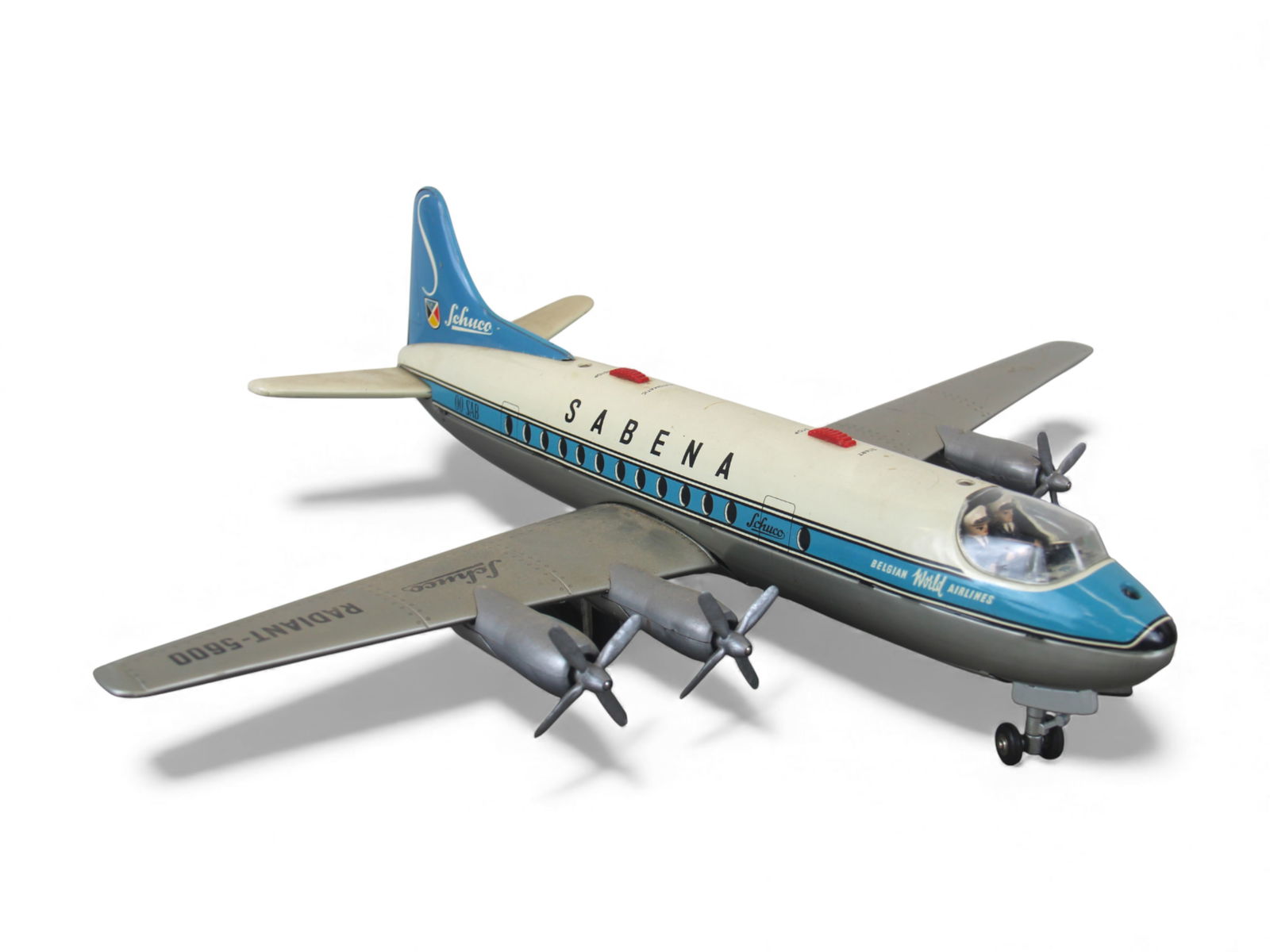 Schuco Radiant-5600 Sabena Airliner: Litho tin with plastic parts, 19" WS. It is battery operated, and only sputtered a few times when tested. It has a spotless battery box and shows light use. Missing steering tether. Shipping: Weiss