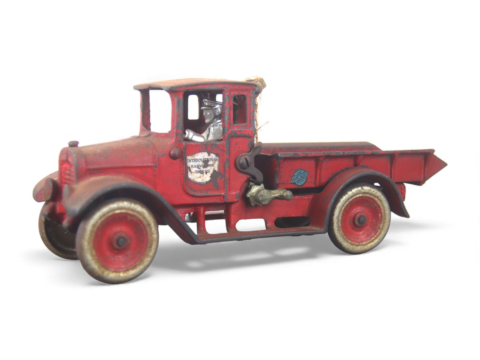 Arcade IH Red Baby Dump Truck: Painted cast Iron with metal wheels & Nickel Driver, 10" long. It has good decals and shows moderate play wear and would benefit from a clean and polish. Shipping: Weiss Auctions offers full-service,