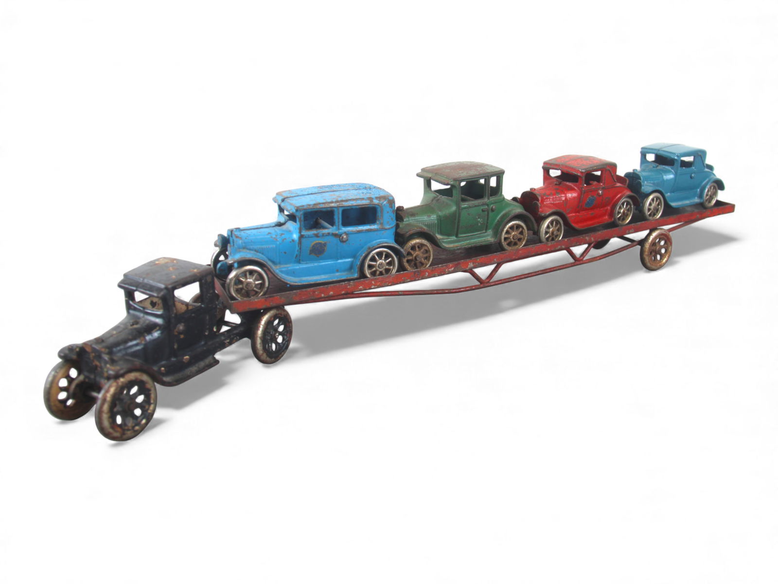 Large Arcade Car Carrier: Painted cast iron with nickel plates wheels, over-all length 24". The tractor is repainted, trailer shows moderate wear. 3 cars are original showing moderate wear, blue coupe is a nice restoration. 
