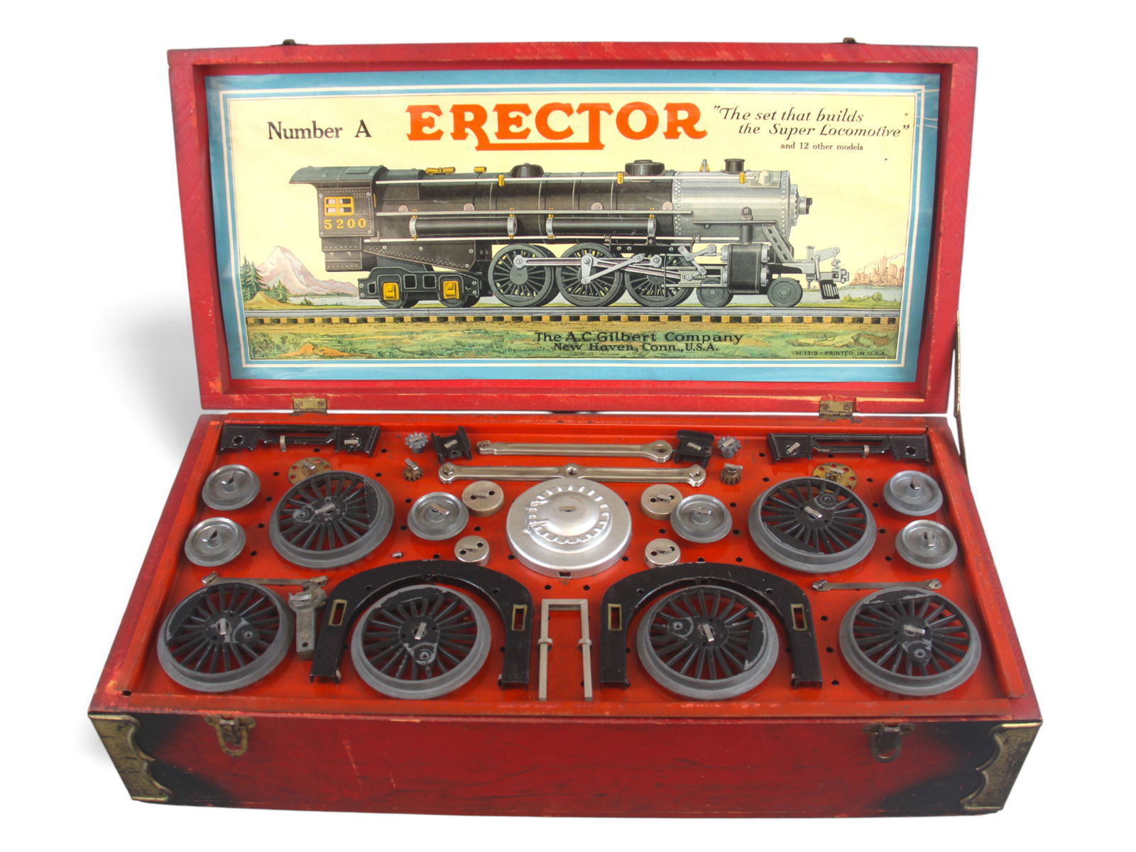 Boxed A.C. Gilbert Erector No. A "Locomotive" Set: Vintage A.C. Gilbert Erector No. A "The Locomotive" construction set, circa early 1930s, housed in its original red wooden case with black corner shading. The interior lid features the classic