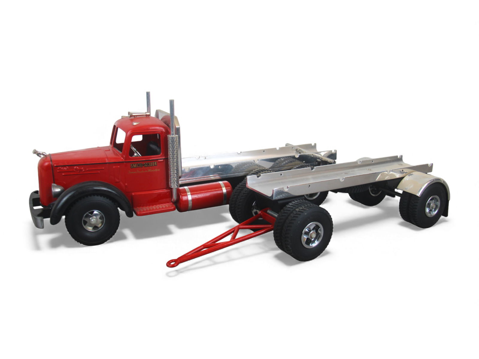 Fred Thompson Smith-Miller Lumber Truck: Beautifully made in the Smith-Miller style. Includes Mack tractor & pup, no load, over-all 27" long. It is dusty, but like new. Shipping: Weiss Auctions offers full-service, in-house shipping for near