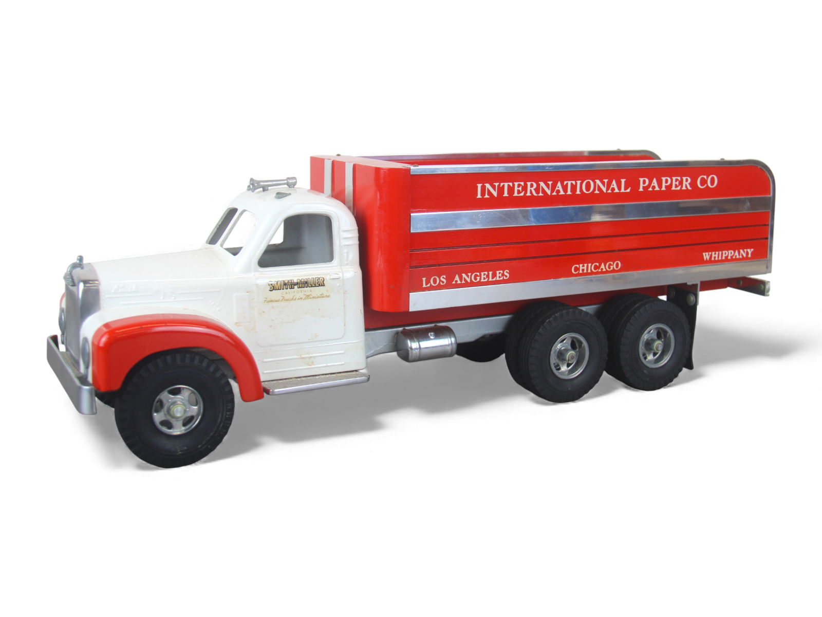 Fred Thompson Smith-Miller Paper Truck: Beautifully made 10-wheeler in the Smith-Miller style, 20 1/2" long. Includes B-Mack tractor with International Paper lettering. It is dusty, but like new. Shipping: Weiss Auctions offers full-service