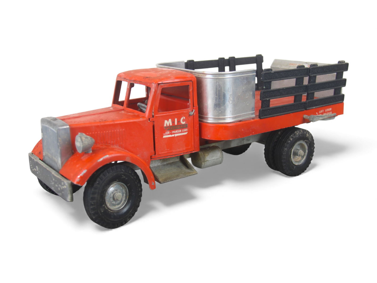 Vintage Smith-Miller MIC Delivery Truck: Nice B-Mack stake truck. Painted die cast with rubber tires, 18" long. It has a working lift gate with opening doors and steerable wheels. It would greatly benefit from a good clean and polish. Bumper