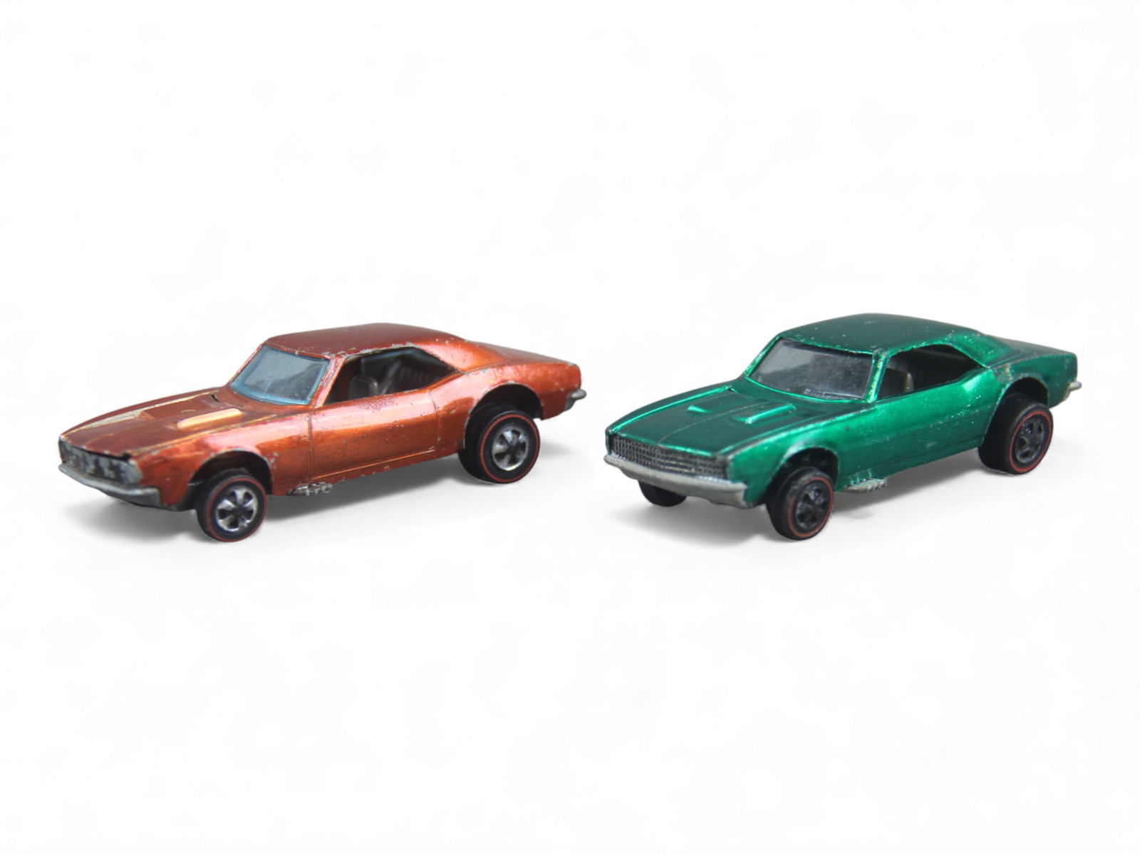 Two 1967 Mattel Hot Wheels Red Line Cameros: Sweet 16! Includes a Spectra-Flame orange example with brown interior and blue windows. It is evenly lightly toned with opening hood with slight bend on cowl bellow windshield; Spectra-Flame green