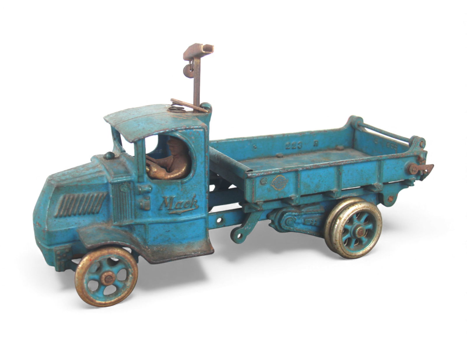 Arcade Mack T-Bar Dump Truck: Painted cast iron with nickeled wheels, 11" long. It is missing the rope, crank and 1 pulley. retains 88% paint. Driver is oxidized as is the T-Bar. Should clean-up with care. Shipping: Weiss Auctions