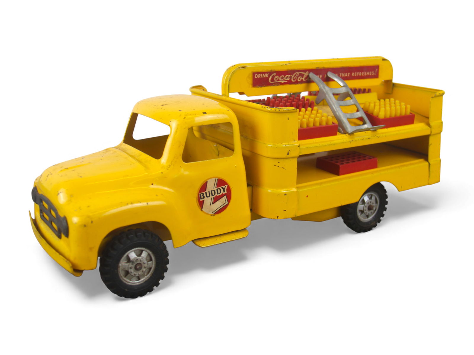 1955 Buddy L Coca-Cola Truck: Painted Pressed steel with rubber tires, 14 1/2" long. It has nice decals all around & retains 6 complete soda trays, 2 additional missing inserts with both hand-trucks. It would greatly benefit from