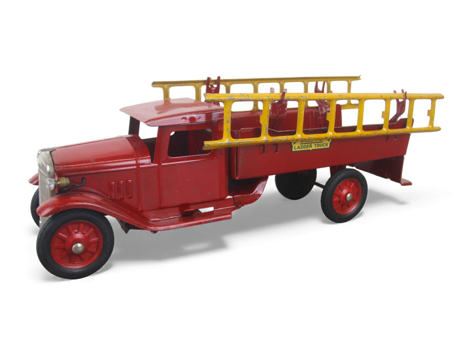 Buddy L Deluxe Ladder Truck: 1932. It is painted pressed steel with rubber wrapped spoke-cast hubs, 21" long. It has nice decals, original ladders and operating headlights, untested. it shows light play wear. Nice! Shipping: Weis