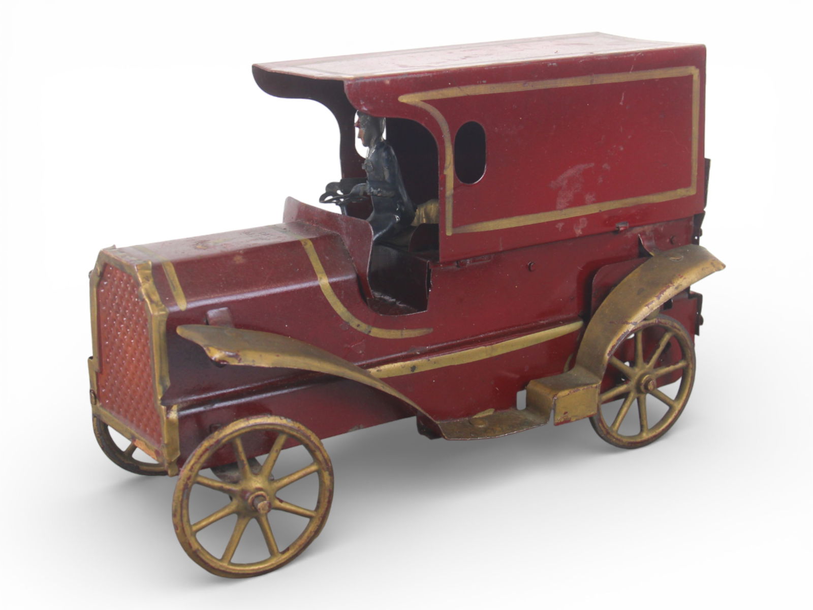 Nice Dayton Delivery Truck: 1920, Hand-painted pressed tin, 10 1/2" long. It has a functional hill-climber mechanism. Driver is vintage, but tin, out of another toy. It has unusually nice paint, with tulip motif on hood. Nice