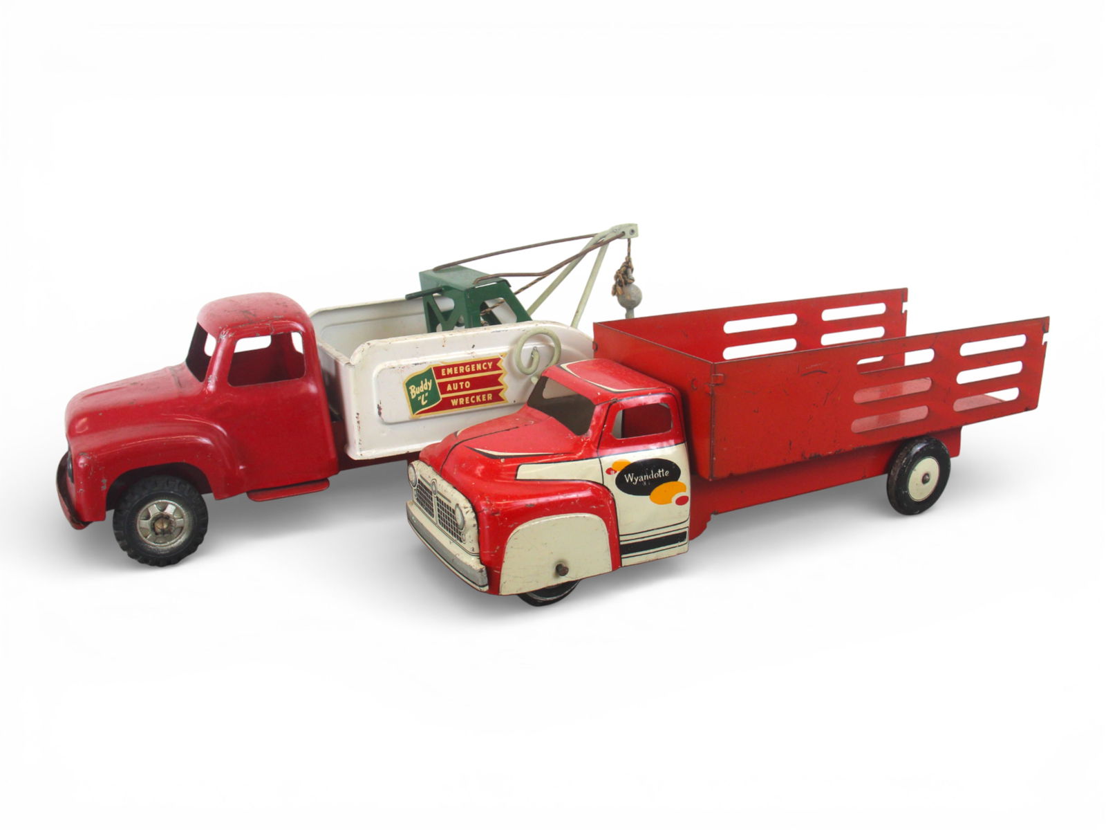 Buddy L & Wyandotte Toy Trucks: Includes a 1958 Buddy L Wrecker. Boom support oxidized and bent, missing spare tires, has original hook; Wyandotte Delivery Truck, 17" long, missing rear gate. They show light to moderate play wear. S