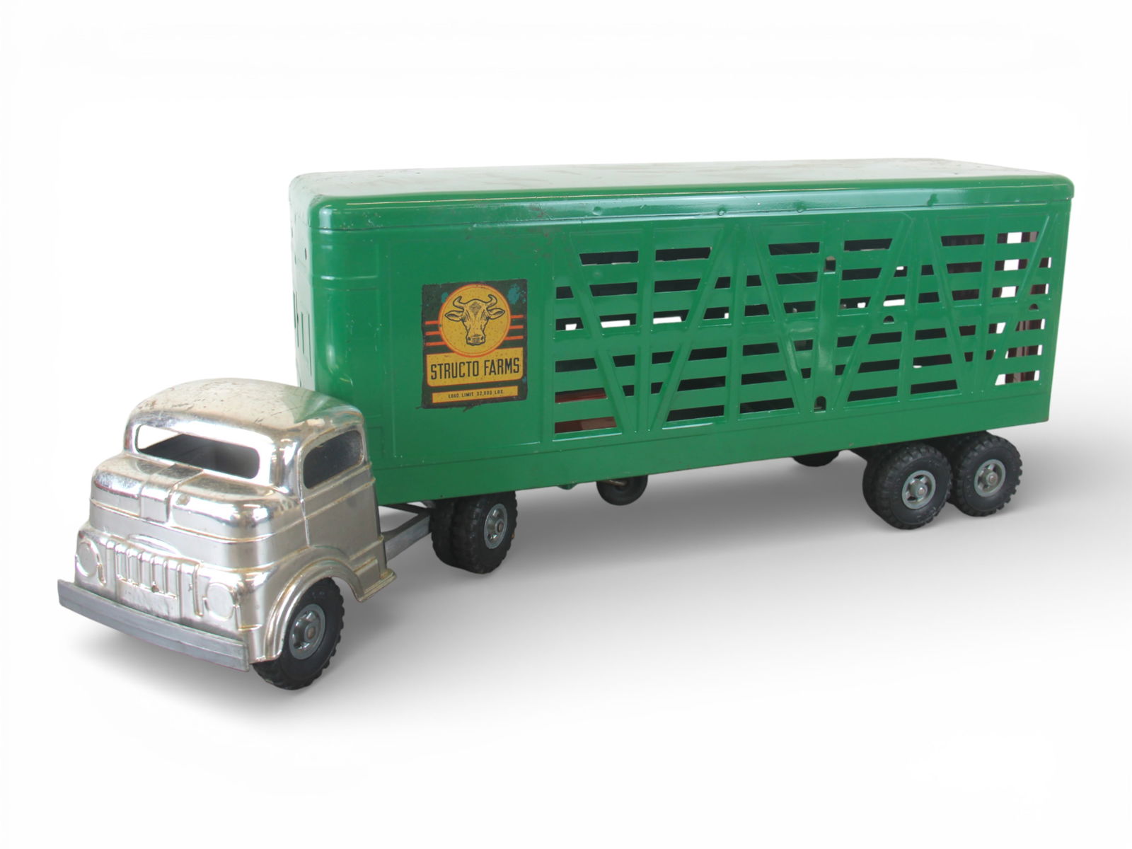 Clean 1955 Structo Livestock Truck: COE tractor is intact with rubber tires over cast detailed hubs; Trailer is clean and shiny, decals are bright and 100%, rear doors are present. It shows light play wear. Shipping: Weiss Auctions