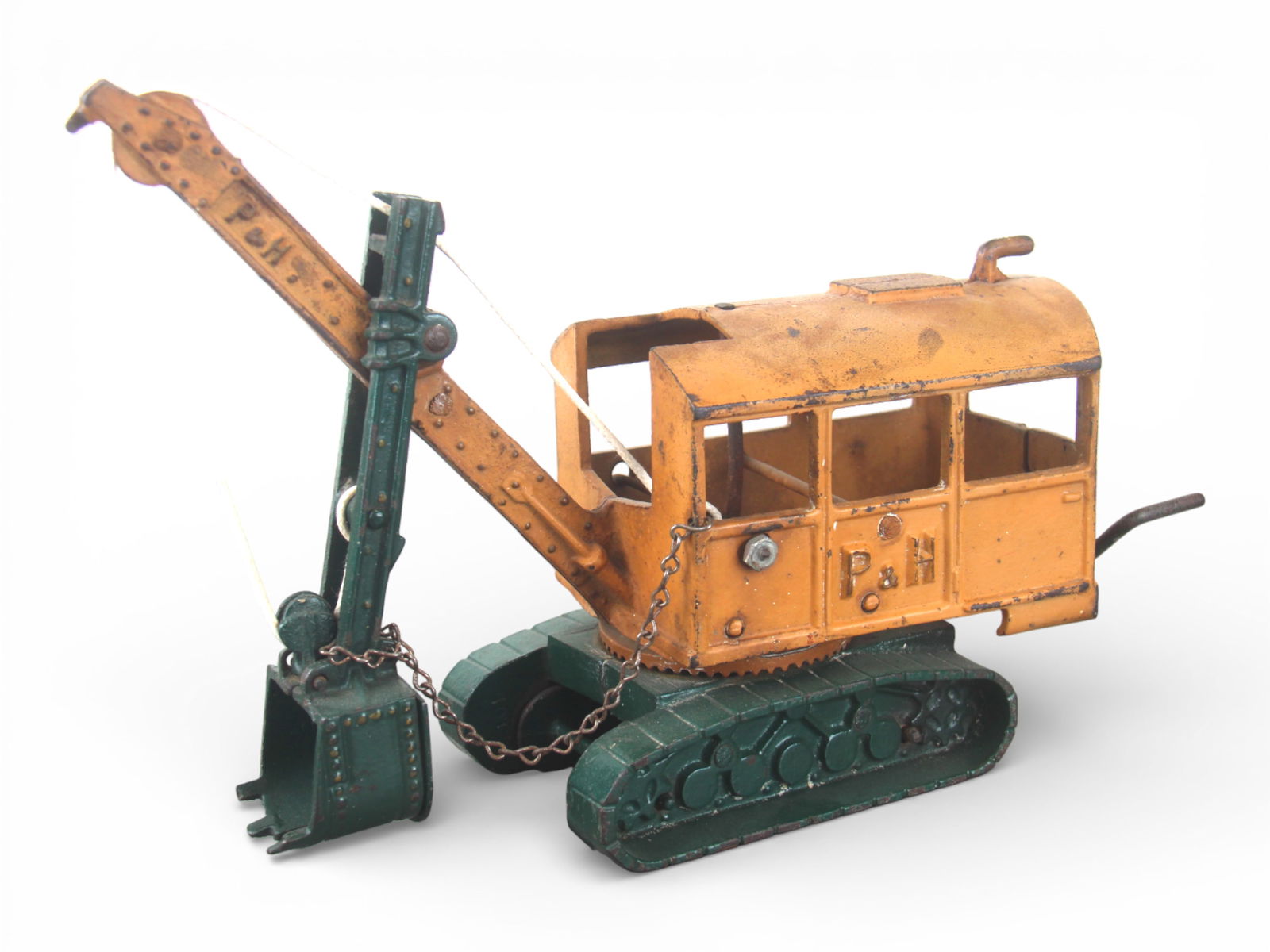 Rare Vindex P&H Steam Shovel: Very rare example, cast iron, painted in tan body with green treads, boom and shovel, raised side lettering, 14" Long. Rear crank rotates body, side crank elevates shovel, replaced string a very diffi