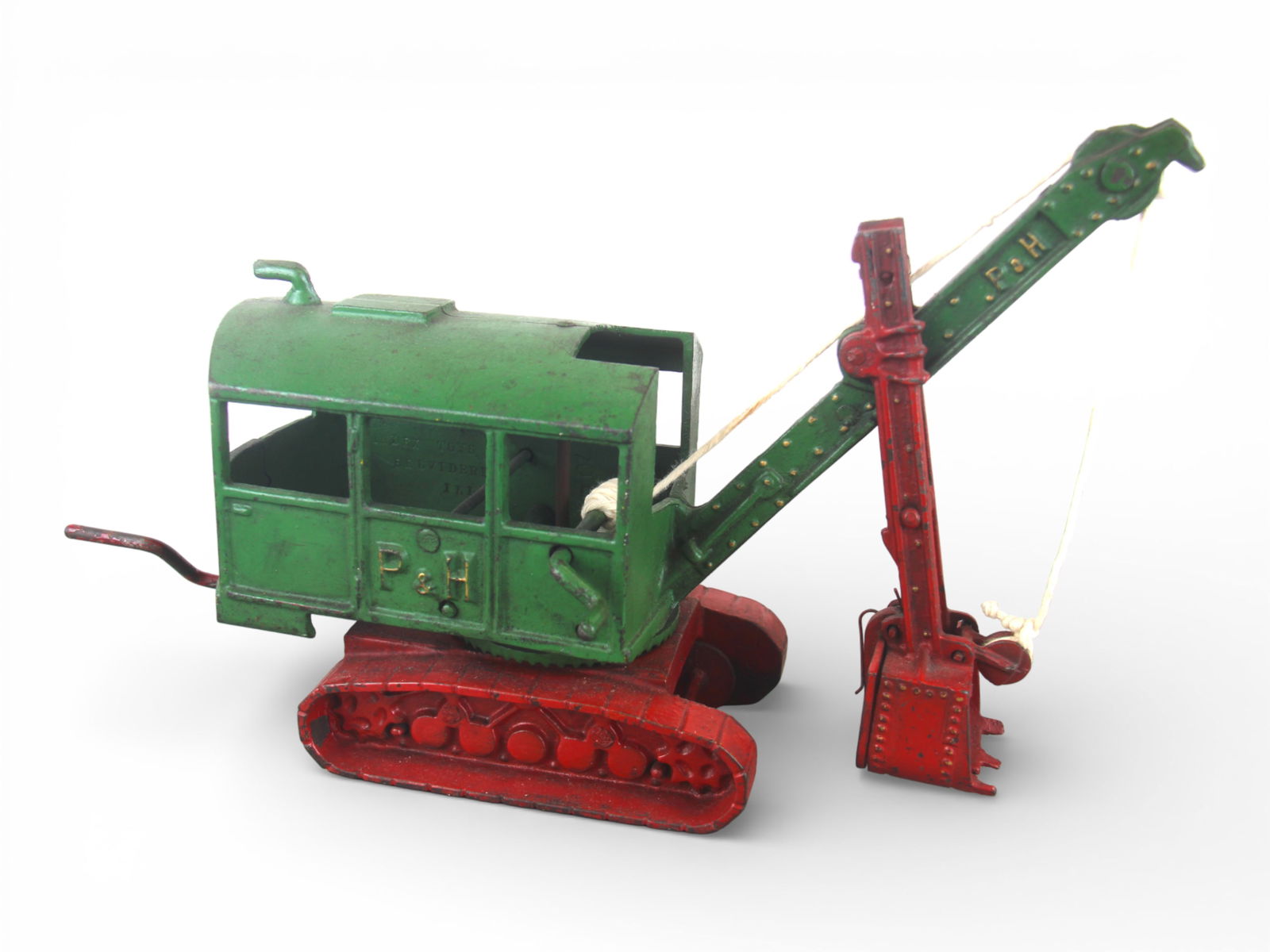 Rare Vindex P&H Steam Shovel: Very rare example, cast iron, painted in green body with red treads, boom and shovel, raised side lettering, 14" Long. Rear crank rotates body, side crank elevates shovel, replaced string a very diffi