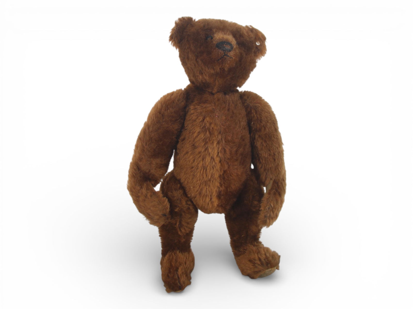 12 Inch Steiff Jointed Mohair Teddy Bear: Vintage Steiff jointed teddy bear, Germany, circa 1920-30's. Approximately 12 inches tall. Constructed with mohair plush, button glass eyes, stitched triangular nose with vertical mouth stitching, and