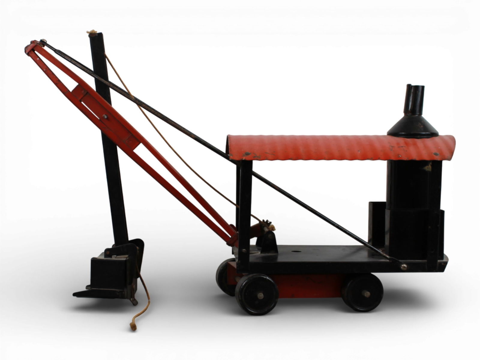 Kelmet White Steam Shovel: Painted pressed steel, 21" long. It has 90% decal on back, much better paint than usually seen on these, just needs a cleaning. Shows light play wear.From the Gary Slutzky Collection of Pressed