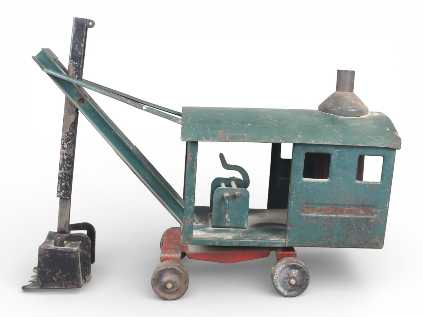 Unusual Sturditoy Steam Shovel: Painted pressed steel, 21" long. It is the only Steam Shovel with a dig feature, allowing the scoop to extend downward. It is all original, missing some rigging and boiler door. It shows moderate