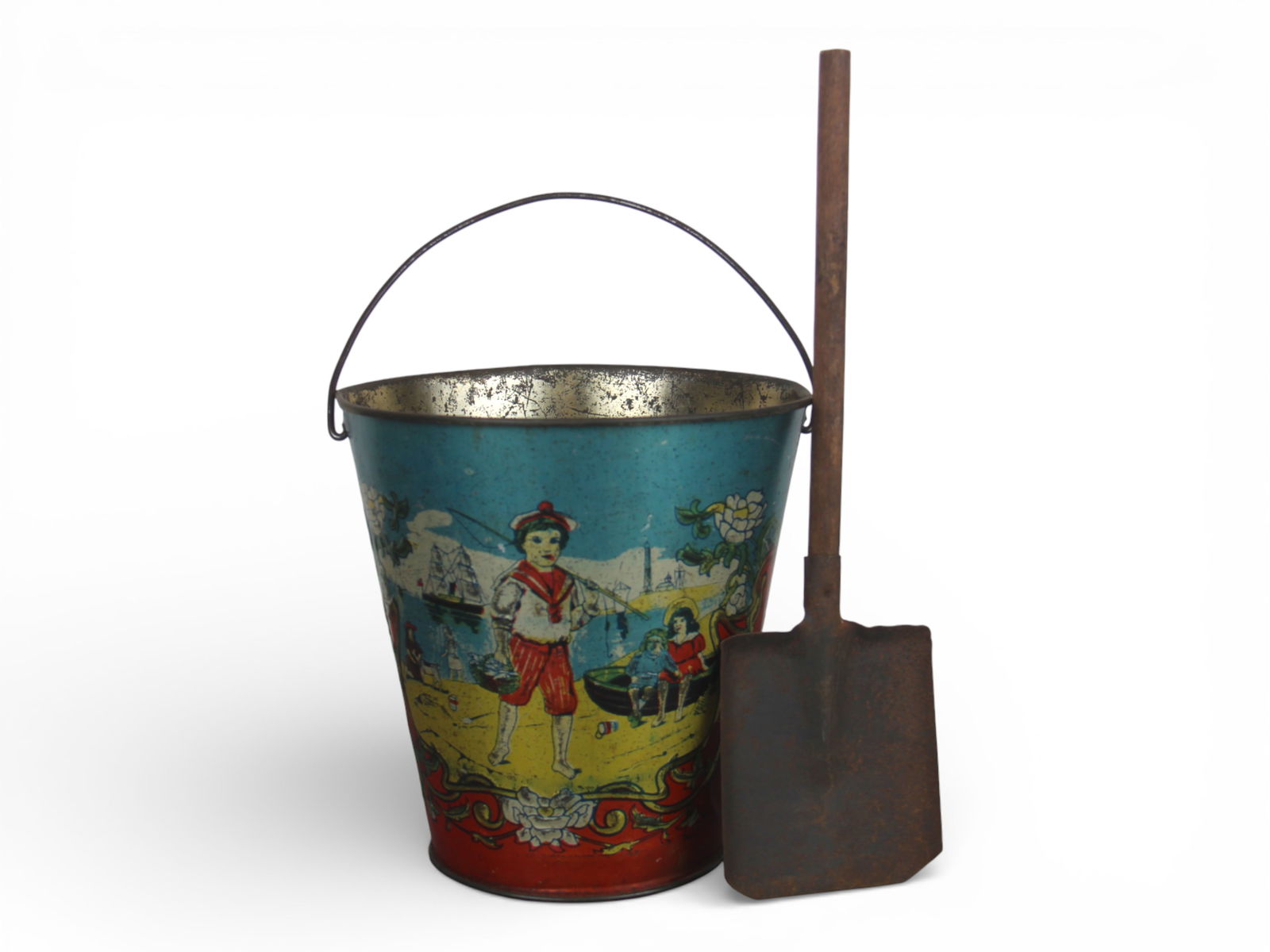 Antique Tin Litho Child's Sand Pail: Likely German or English maker. Features colorful seaside scenes depicting children at play with sailboats, buckets, etc. Approx. 6-3/4" tall. Includes antique shovel, approx. 11" long. Pail shows