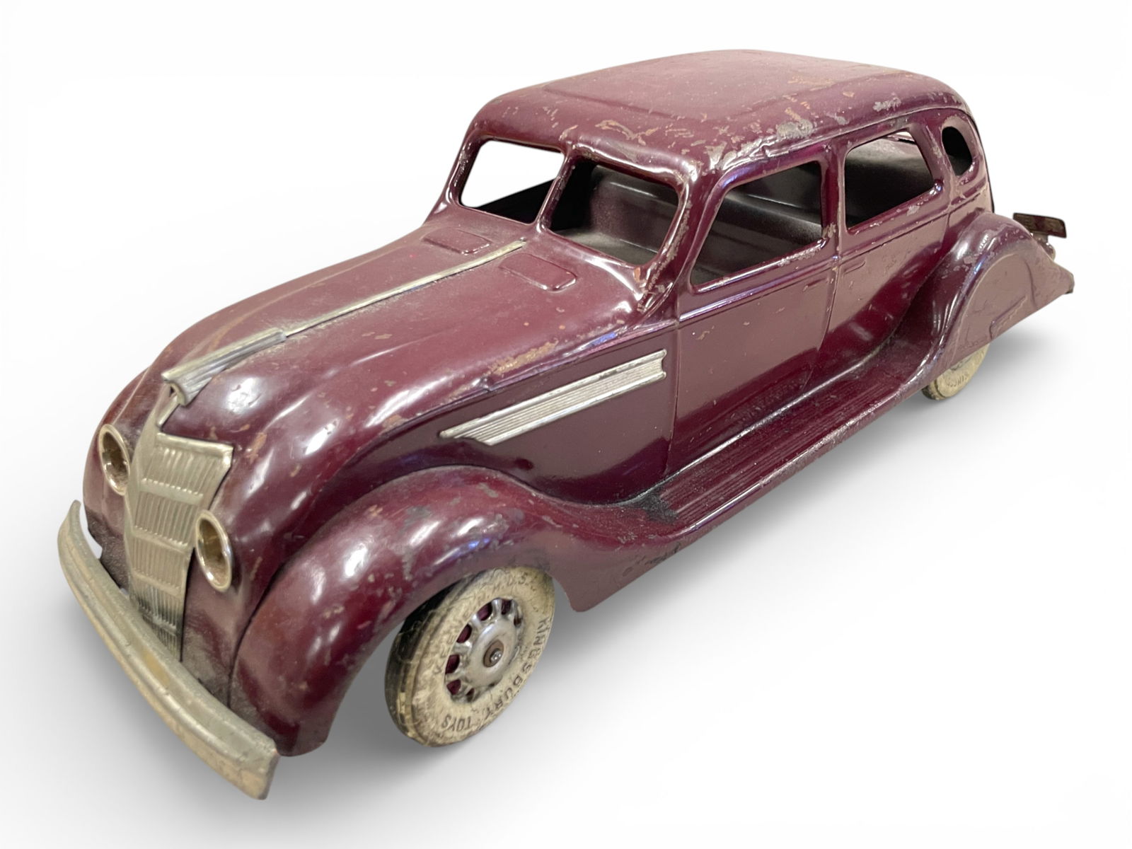 Pressed Steel 1935 Chrysler Airflow: Painted Pressed steel with WRT, 14" long. Has a functional mechanism, with battery horn, untested, but clean battery box. It would benefit from a light cleaning. Shipping: Weiss Auctions offers