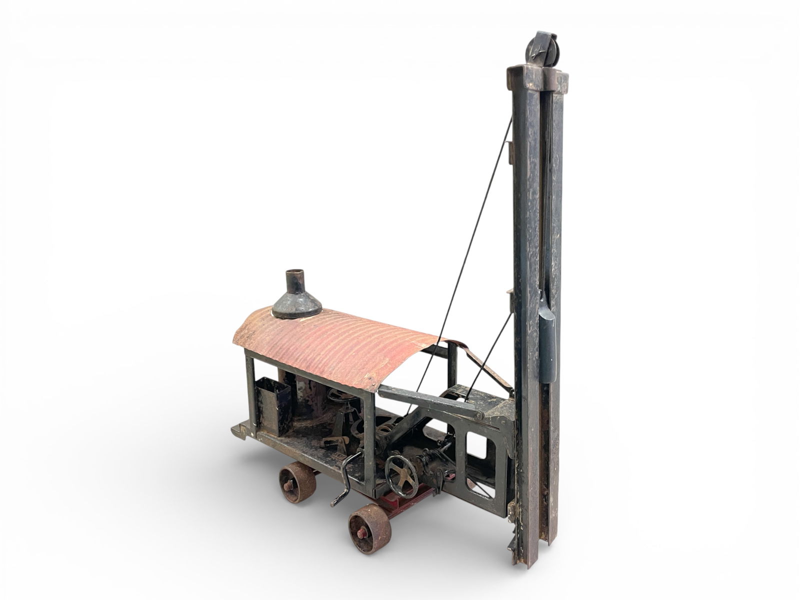 Scarce Buddy L Steam Pile Driver: 1920s, Painted Pressed steel, 19" long. It is intact and functional, but some parts are rusted. Great candidate for restoration. Shipping: Weiss Auctions offers full-service, in-house shipping for