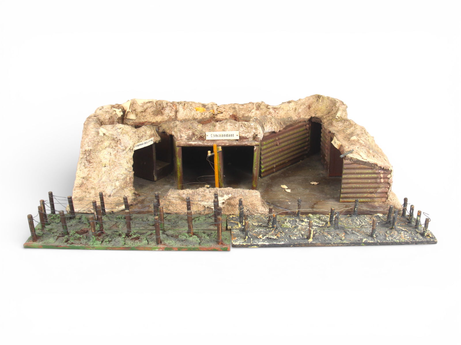 Elastolin or Lineol Commandant Bunker: Elastolin and/or Lineol Commandant Bunker with 4 barb wire trench accessories. Some wear. Bunker measures approx. 24'' x 13'' x 8''. Shipping: Weiss Auctions offers full-service, in-house shipping